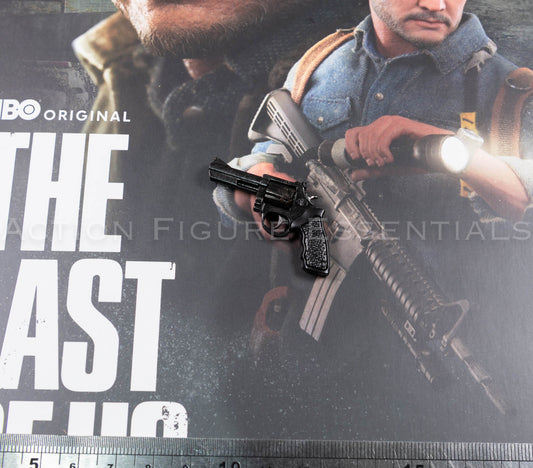 Hot Toys Joel Miller black revolver in 1/6 scale, showing textured grip, detailed cylinder, barrel and subtle worn highlights