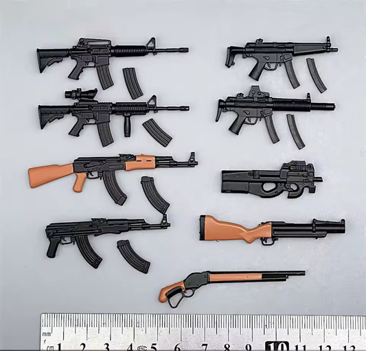 Collection of toy guns and magazines on a white background with a ruler for scale.