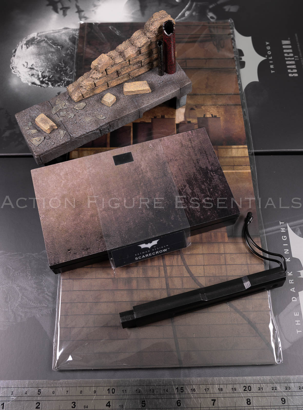 Hot Toys Scarecrow 2.0 MMS801 city sewer diorama display set with weathered brick wall, pipes, rubble, display base and printed backdrop