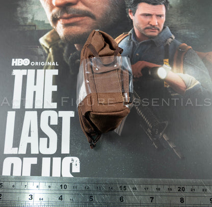 Hot Toys Joel Miller brown backpack in 1/6 scale, showing textured fabric, weathered straps and silver duct-tape repair detailing