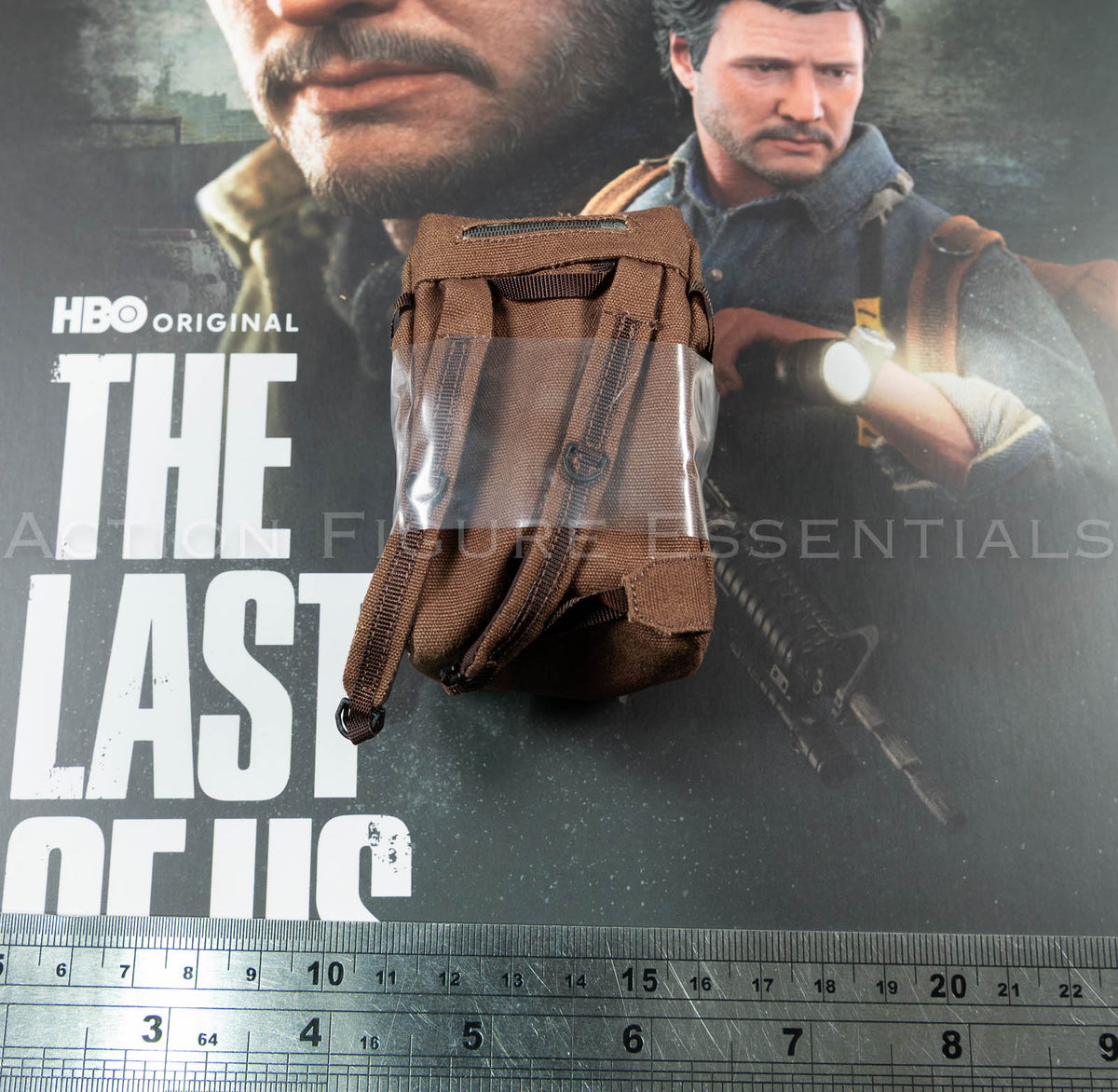 Hot Toys Joel Miller brown backpack in 1/6 scale, showing textured fabric, weathered straps and silver duct-tape repair detailing