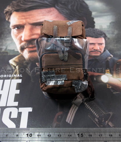 Hot Toys Joel Miller brown backpack in 1/6 scale, showing textured fabric, weathered straps and silver duct-tape repair detailing
