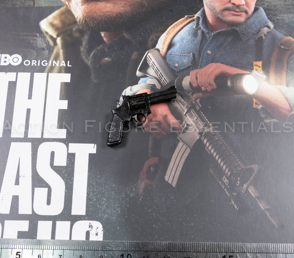 Hot Toys Joel Miller black revolver in 1/6 scale, showing textured grip, detailed cylinder, barrel and subtle worn highlights